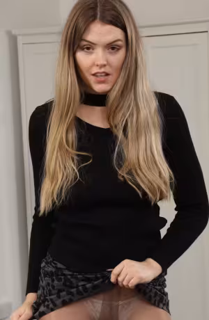 Rosie D from Only Secretaries in a short miniskirt with high heels and pantyhose