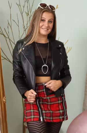 Lucy Ava from Only Tease in a plaid miniskirt with sneakers and black patterned tights